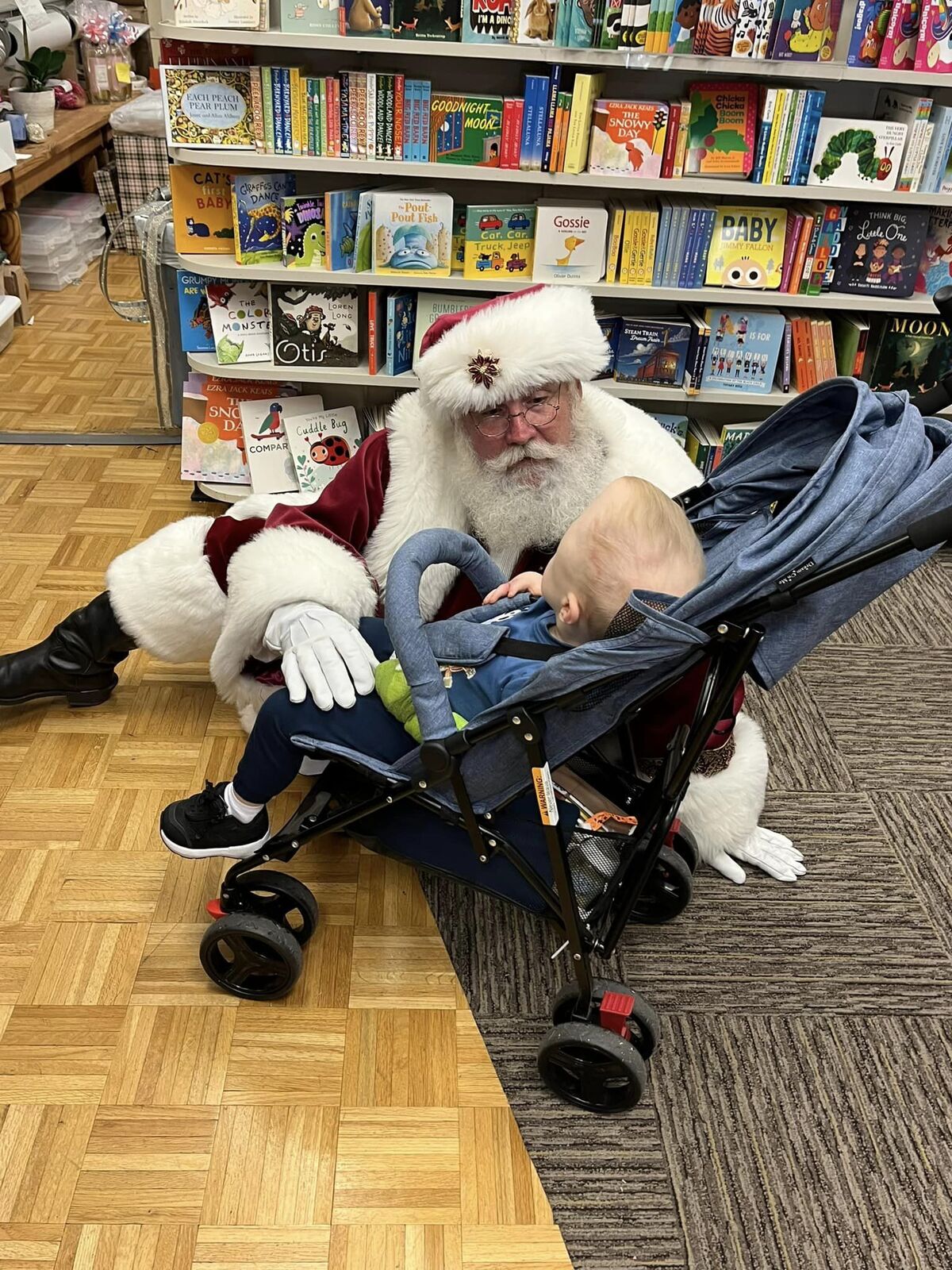 Santa Sarge visiting a local bookstore with a family