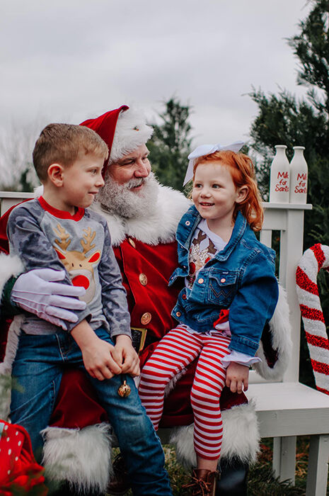Two children with Santa Sarge on a bench